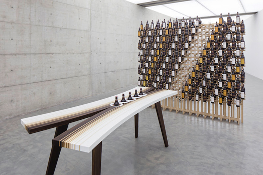 vertical craft beer bottles on curved tasting table