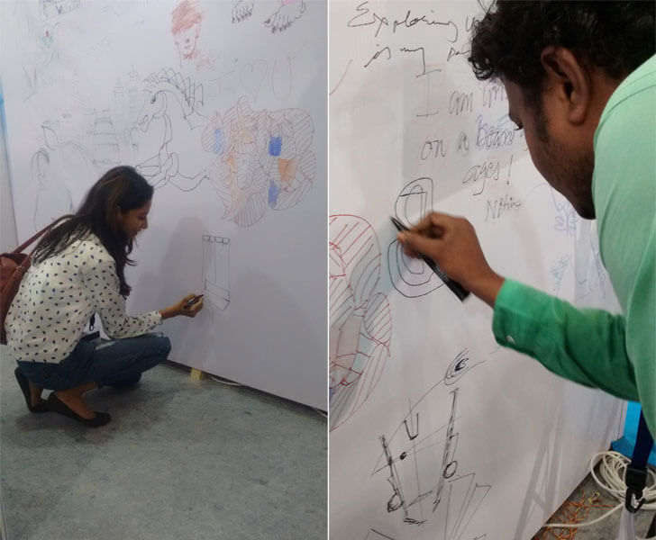 Visitors sketching on the art wall