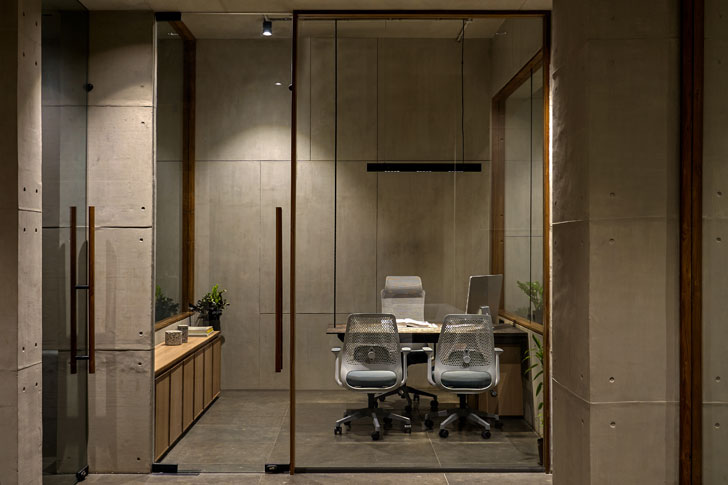 glass partitions evoke seamlessness at surat office designed by sharran architecture plus design