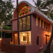 facade view by night of the vaulted roof house in goa designed by 19dotarchitects