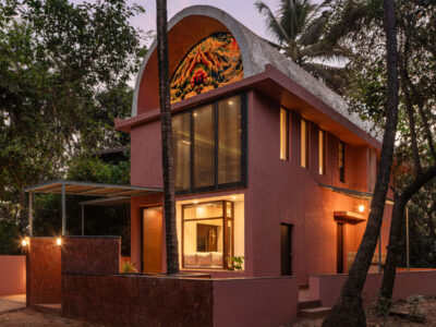 facade view by night of the vaulted roof house in goa designed by 19dotarchitects