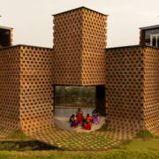 facade of petti restaurant made from earth-clad shipping containers designed by wallmakers