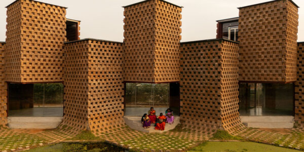 facade of petti restaurant made from earth-clad shipping containers designed by wallmakers