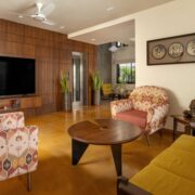 living room at nirhans bungalow vadodara where the staircase acts as the climatic spine. designed by studio yamini architects