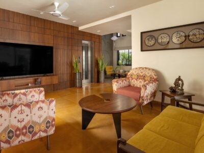 living room at nirhans bungalow vadodara where the staircase acts as the climatic spine. designed by studio yamini architects