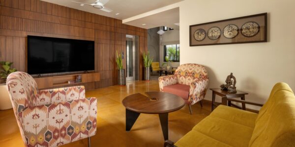 living room at nirhans bungalow vadodara where the staircase acts as the climatic spine. designed by studio yamini architects