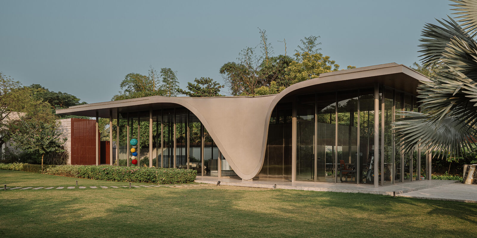 The Dip Pavilion by andblack design studio explores where a home ends and the landscape begins.