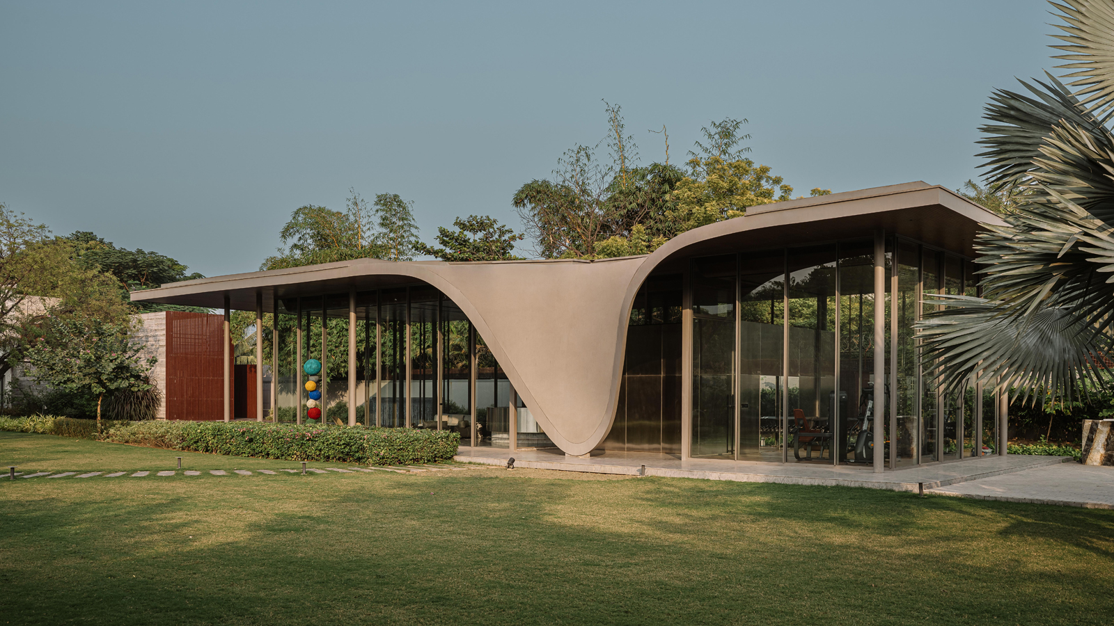 The Dip Pavilion by andblack design studio explores where a home ends and the landscape begins.