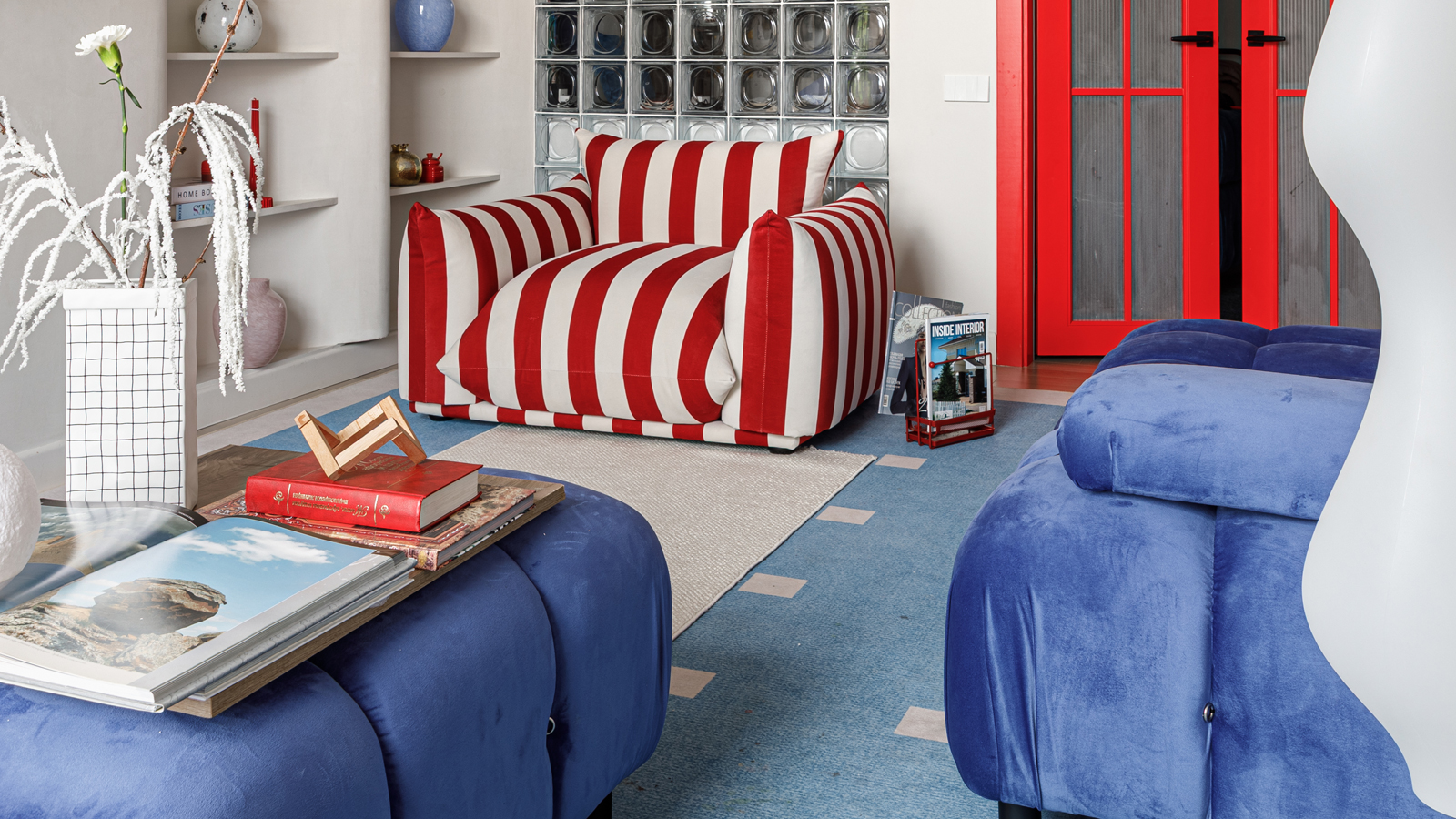 Aktau apartment by SaBelle Design Group that builds its identity around a striking dialogue between red and blue.